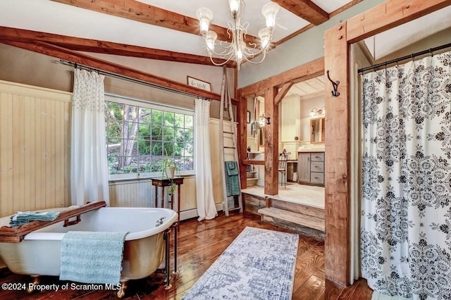 interior space with a bathing tub, hardwood / wood-style flooring, lofted ceiling with beams, and an inviting chandelier