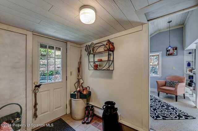 entryway with wood ceiling, vaulted ceiling, and a baseboard heating unit