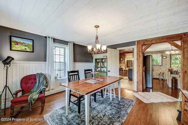 dining room featuring dark hardwood / wood-style floors and an inviting chandelier