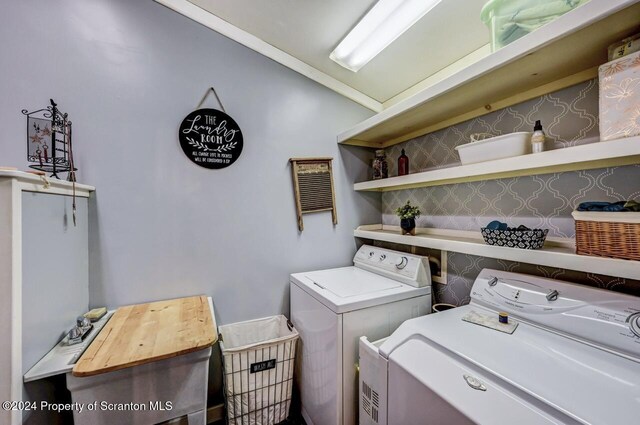 clothes washing area with washer and clothes dryer