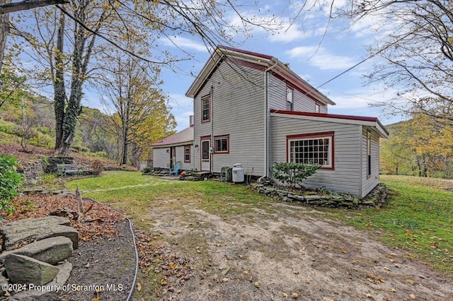 rear view of property featuring a yard