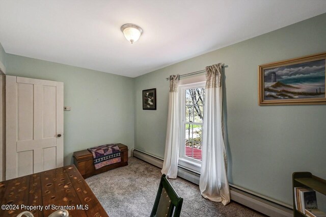 carpeted bedroom featuring a baseboard radiator