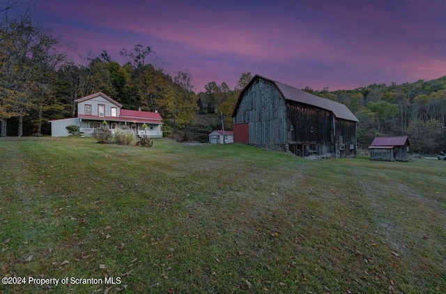 yard at dusk with an outdoor structure