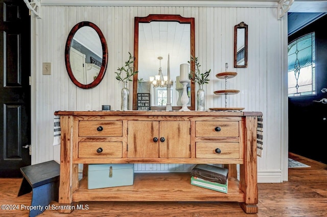 interior space with vanity, wood-type flooring, and an inviting chandelier