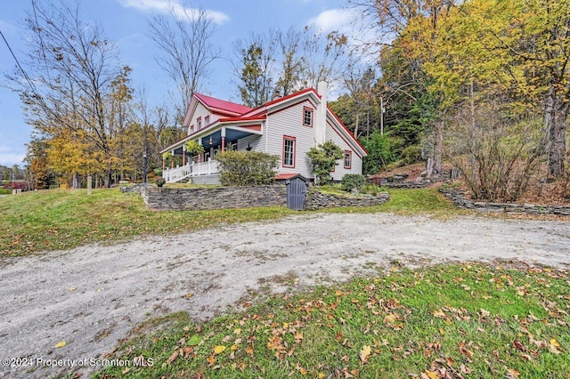 view of side of home featuring a porch