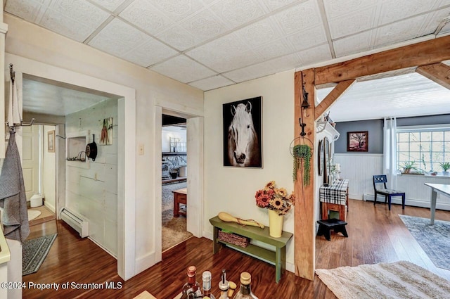 hall with dark hardwood / wood-style floors and a baseboard heating unit