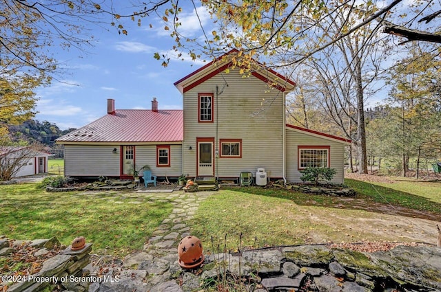 back of house with a yard