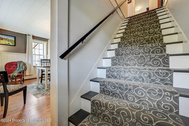 staircase with wood-type flooring