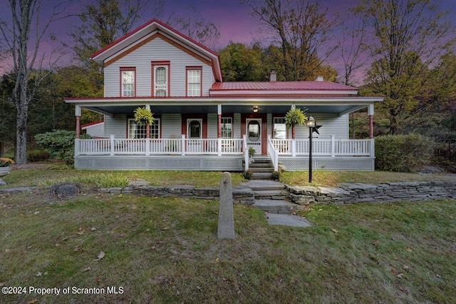 view of front of home featuring a yard and covered porch