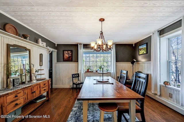 dining area featuring ornamental molding, baseboard heating, dark wood-type flooring, and a notable chandelier