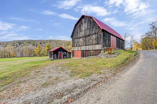 view of property exterior with an outdoor structure