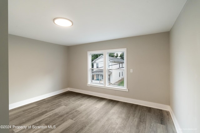 empty room featuring dark wood-type flooring