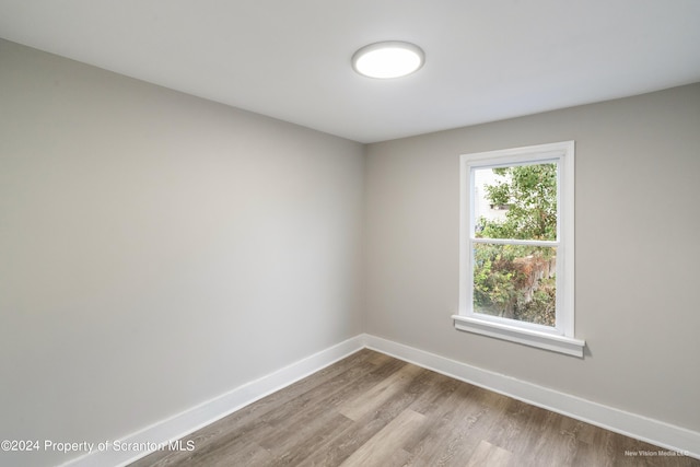 empty room with light hardwood / wood-style flooring