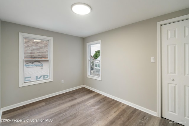 empty room with hardwood / wood-style flooring