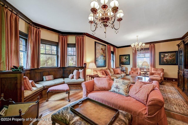 living room featuring hardwood / wood-style floors, a chandelier, and ornamental molding