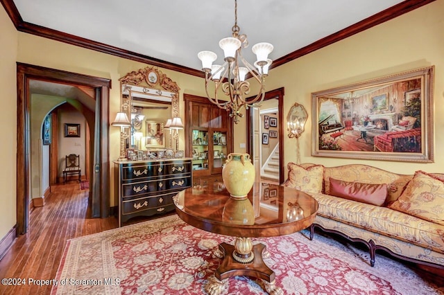 interior space featuring crown molding, dark wood-type flooring, and a notable chandelier