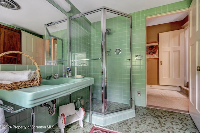 bathroom featuring tile patterned floors and a shower with shower door