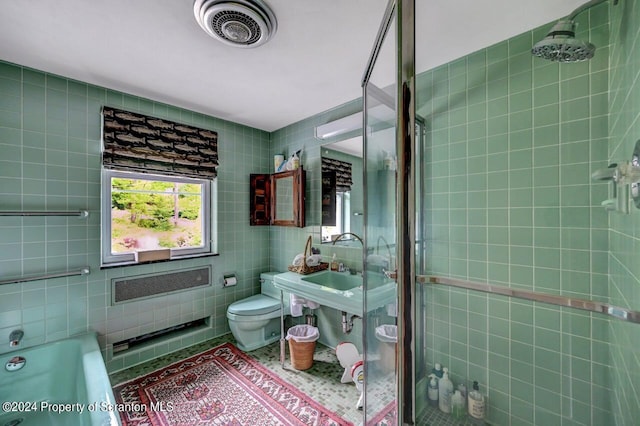 full bathroom featuring sink, plus walk in shower, tile walls, and toilet