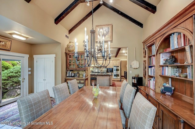 dining area featuring beam ceiling, high vaulted ceiling, and an inviting chandelier