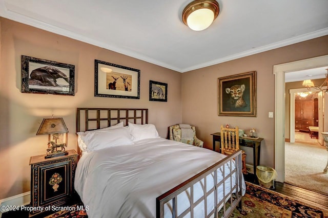 bedroom featuring carpet, an inviting chandelier, and ornamental molding