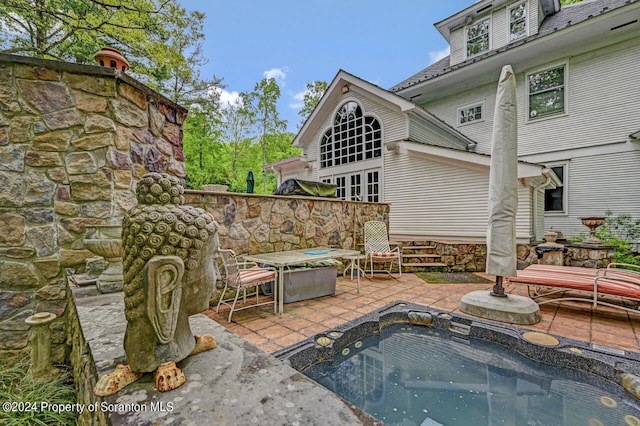 view of patio / terrace featuring a hot tub