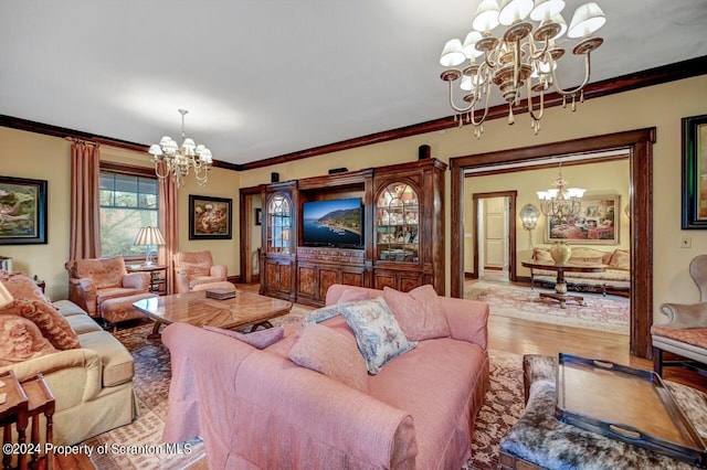 living room featuring hardwood / wood-style floors, a chandelier, and ornamental molding