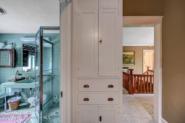 bathroom with a shower and crown molding