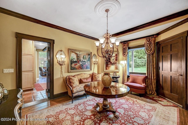 living room featuring an inviting chandelier, crown molding, and light hardwood / wood-style flooring