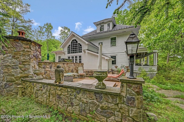 back of property with a patio