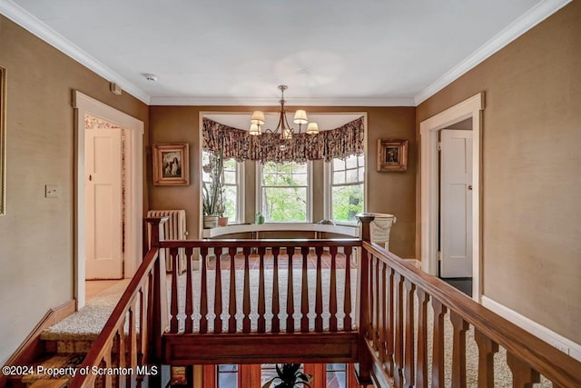 staircase featuring crown molding, radiator, and a chandelier