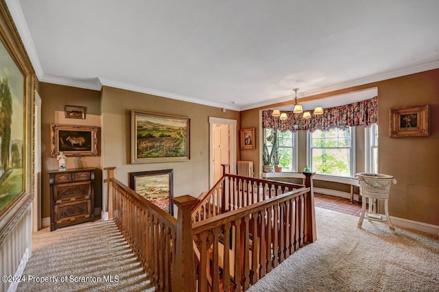 corridor with carpet floors, crown molding, radiator, and a chandelier