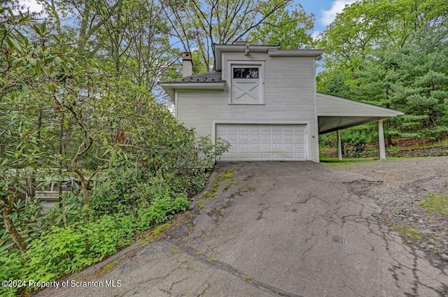 view of home's exterior featuring a garage and a carport