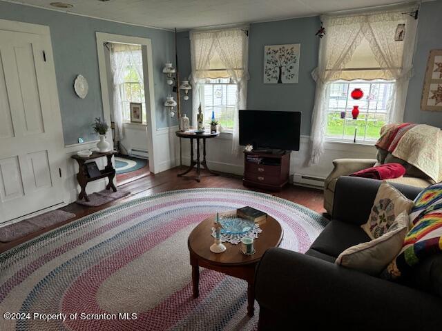 living room featuring hardwood / wood-style flooring and baseboard heating