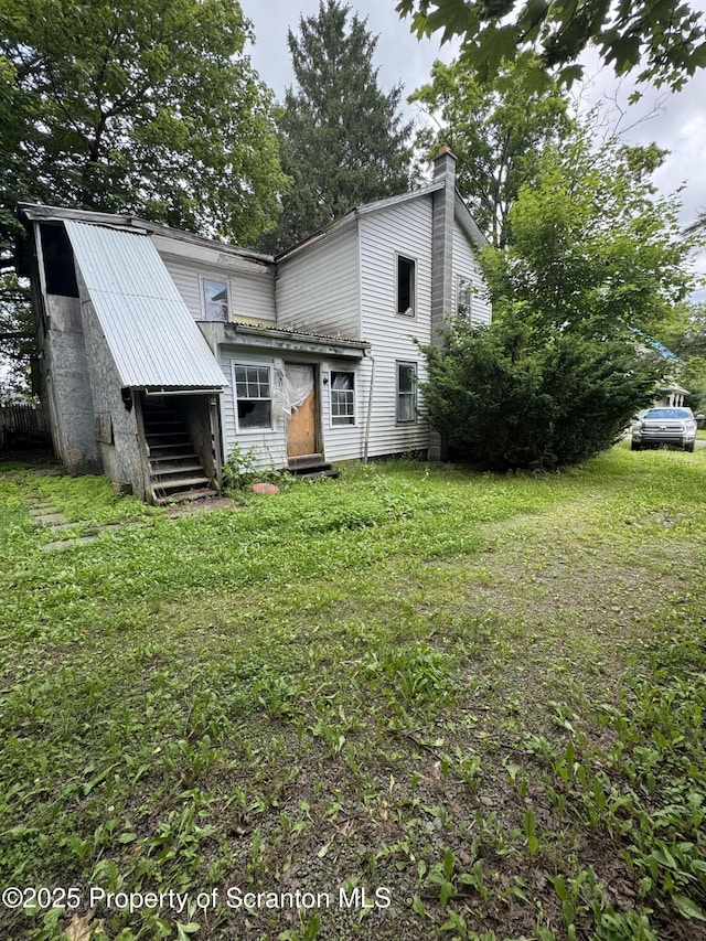 41 William St, Hallstead, PA 18822 - back of house featuring a chimney and a yard