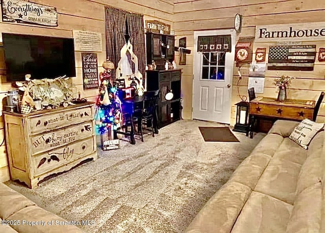 living room with carpet floors and wooden walls