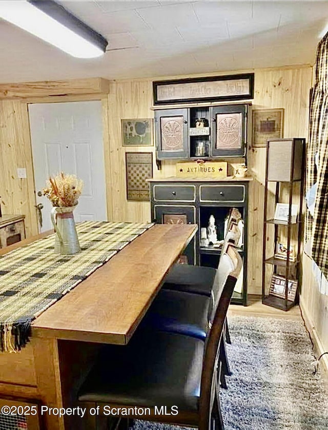 dining space with wood walls