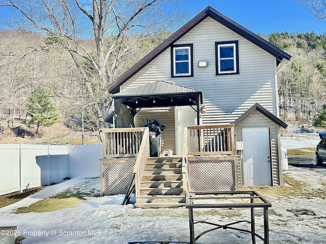 view of front of property with stairway, a wooden deck, fence, and a gazebo