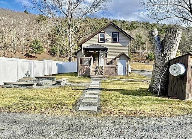 view of front of property with fence and a front lawn