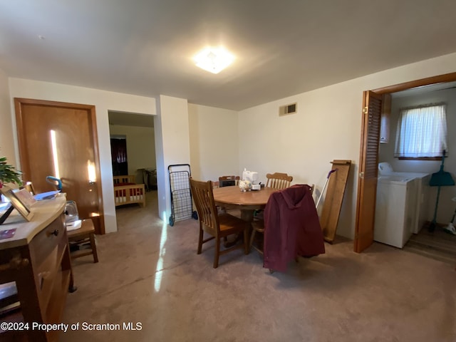 dining area with concrete flooring and washer / clothes dryer