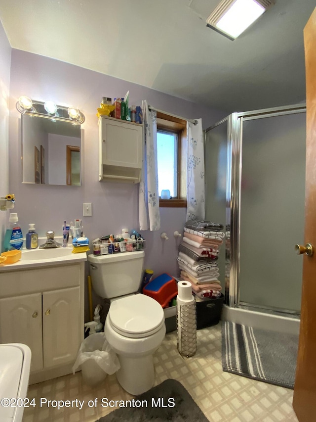 bathroom with vanity, toilet, and walk in shower