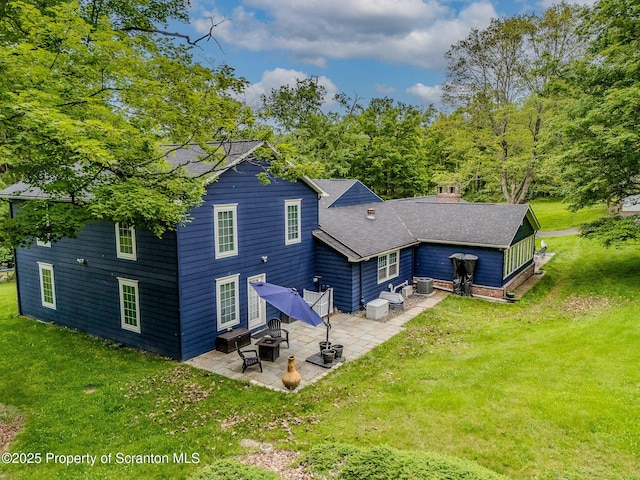 941 Old State Rd, Clarks Summit, PA 18411 - back of property featuring a patio area, a yard, central AC unit, a shingled roof, and entry steps