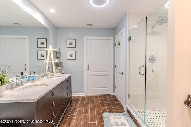 941 Old State Rd, Clarks Summit, PA 18411 - full bath with a stall shower, double vanity, wood finished floors, and baseboards