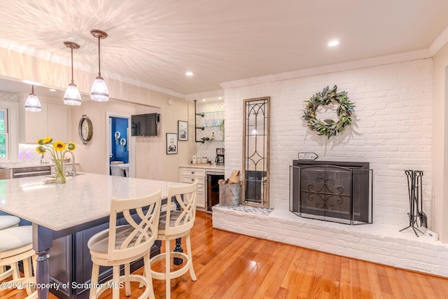 941 Old State Rd, Clarks Summit, PA 18411 - dining room featuring crown molding, light wood-style flooring, beverage cooler, a fireplace, and recessed lighting