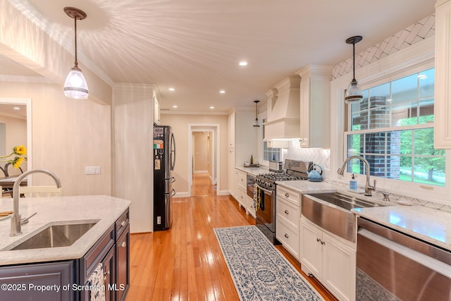 941 Old State Rd, Clarks Summit, PA 18411 - kitchen featuring stainless steel appliances, a sink, white cabinets, backsplash, and crown molding