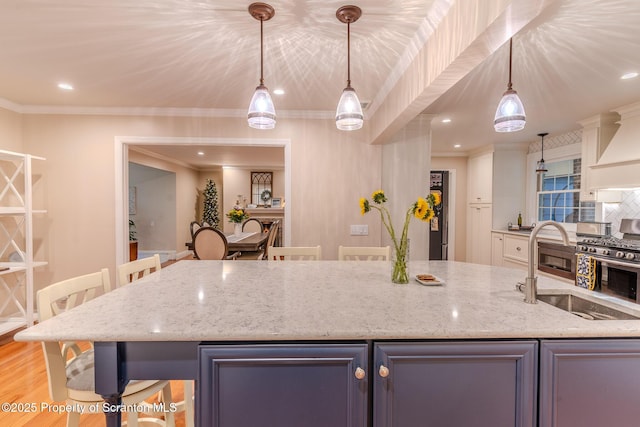 941 Old State Rd, Clarks Summit, PA 18411 - kitchen with ornamental molding, light stone counters, gas range, wall chimney exhaust hood, and hanging light fixtures