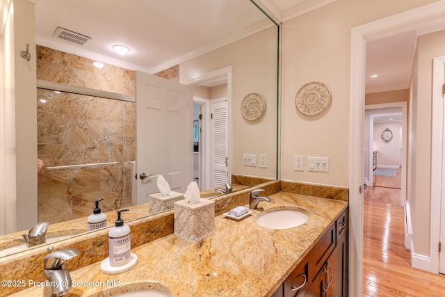 941 Old State Rd, Clarks Summit, PA 18411 - bathroom featuring double vanity, a stall shower, wood finished floors, and ornamental molding