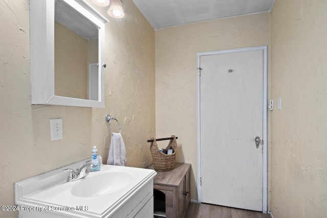 bathroom featuring vanity and wood-type flooring