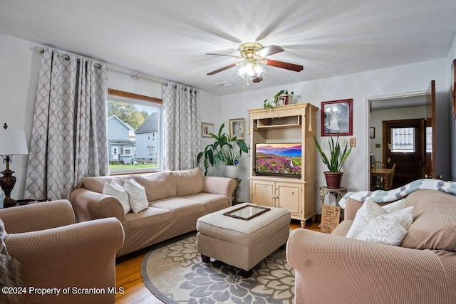 living room featuring ceiling fan and light hardwood / wood-style floors