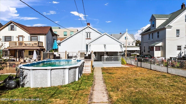 view of pool featuring a wooden deck and a yard