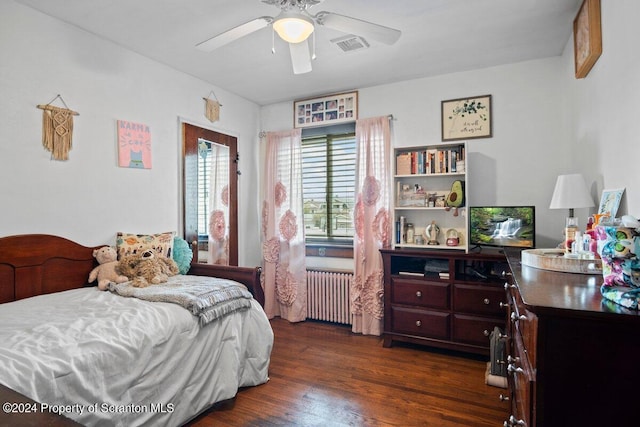 bedroom with ceiling fan, dark hardwood / wood-style flooring, and radiator heating unit